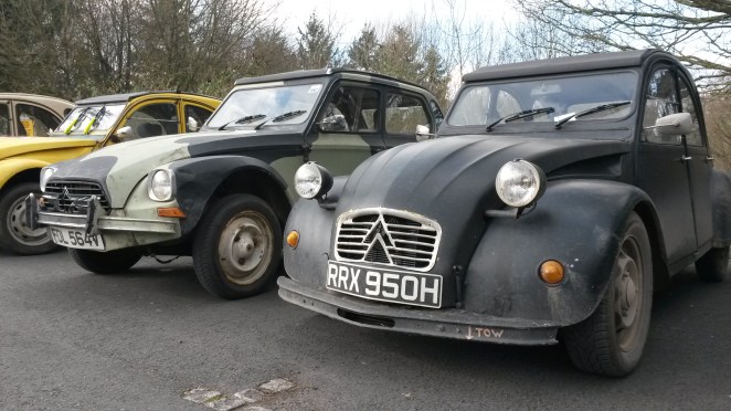 Dyane poses next to BMW 2CV.