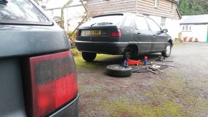 Investigating the rear wheel bearing on the new ZX, while Citroen number 4 looks on.